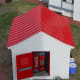 View of modern coke vending machine housed in old fashioned building.