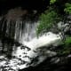 Ko falls, through the summer growth in the forest.