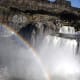 A nearly perpetual rainbow over the falls. No pot of gold, though. The power plant is visible through the mist to the left.
