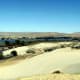 The sand has been shaped by wind and weather for thousands of years now. The river curve is visible in the background.