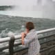 The author's son watches the water thunder past and topple over the precipice.