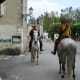 Costumed actors on horseback roam the château property and interact with visitors.