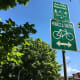 A trail sign beside a road