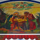 Close-up detail of a mural (painted by Father Gielen) above the church's main entrance.