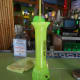 The Hand Grenade ingredients are: gin. grain alcohol, melon liqueur and rum