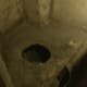 The lavatory at the rear of the building outside is a small yard.