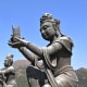 Beside the Buddha are six Deva statues. Each holds a different offering for the Enlightened One.