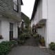 Narrow Lane in Hawkshead Village with pots and hanging baskets in bloom