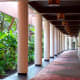Orchid-lined corridor leading to a lush garden.
