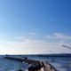 A long dock stretches out to the sea.
