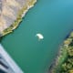 Base jumpers flying over the Snake River after jumping off of the Perrine Bridge in Twin Falls, Idaho.