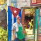 An employee at the entrance to the bar and restaurant Casa del Bilongo.
