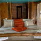 A standard double room with a bed made from locally available wood