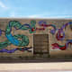 Center photo of the mural by Daniel Anguilu