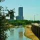 View of Wortham Tower with a flag on top of American General Center along Buffalo Bayou