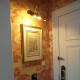 Illuminated print by the door.