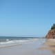 Beach nestled between red rock cliffs in PEI