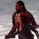 Jason Mamoa and Amber Heard in Aquaman emerge from the ocean.