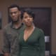 A.J. with his grumpy face on and his wife being more concerned about A.J.'s father than him.