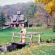 Little Norway with church in background and me standing on a little bridge spanning a creek.