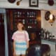 My niece standing by an impressive collection of antiques at Little Norway.