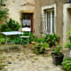Tiny, secluded garden, filled with plants.