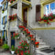 One of the lovely houses in the square, brimming with blooming flowers.