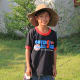 Alisa's brother 'Lucky' standing in the grounds of the temple, wearing my oversized hat while I took my photos
