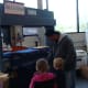Tati explains to Grace and Alex how the die cut machine works.