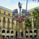 Placa Reial...Many identical buildings in this area on the site of a former Capuchin convent. Many motifs showing explorers of the New World. Many bars and markets in this area.