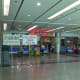 The waiting area, with signs indicating the next departing train. At the rear is a cafeteria.