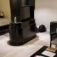 The other side of the entertainment center where the second television is visible with the king sized bed in the background.