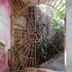 A little hideaway art house with a tree growing inside to keep the residents cool.