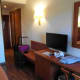 Desk, tv and towards the bathroom and main door.