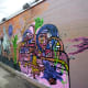 Partial view of a mural by @Zesoner on the side of building from back to front
