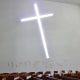 Interior view of the chapel with glass cross cutout & concave stations of the cross