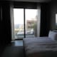 Bedroom with balcony beyond.