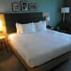 Comfortable King size bed with armchair in the corner.