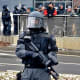 Policeman carries a pepper spray rifle