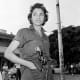 Young woman patrols the streets in post-Batista Havana.