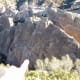 From the upper trail, note where my finger points down. Those little holes in the cliffs are big enough for rock climbers to sit inside. The faint line of holes going up on the right is their ascension "trail."