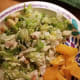 Parmesan salad with orange slices on the side