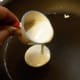 5. Heat pan on medium. Spray pan with non-stick spray, then pour 1/4 cup of batter in pan, just like you would a pancake. Batter will spread out. You can tilt the pan to spread it more.