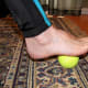 Roll your foot over a tennis ball or can
