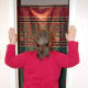Place hands on door frame, with elbows even with shoulders, and lean into door opening