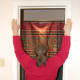 Place hands on door frame, with elbows above shoulders, and lean into door opening
