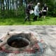 People gather around the now defunct Well 5 where the original water contamination started during a memorial ceremony in Walkerton, Ont., on Sunday, May 16, 2010. (THE CANADIAN PRESS/Nathan Denette)