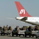 Taliban militia rushing towards the hijacked airliner