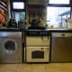 Our washing machine with built-in dryer, in the kitchen next to the cooker; and on the other side of the cooker is the dishwasher.