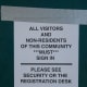 A sign asking visitors to sign in